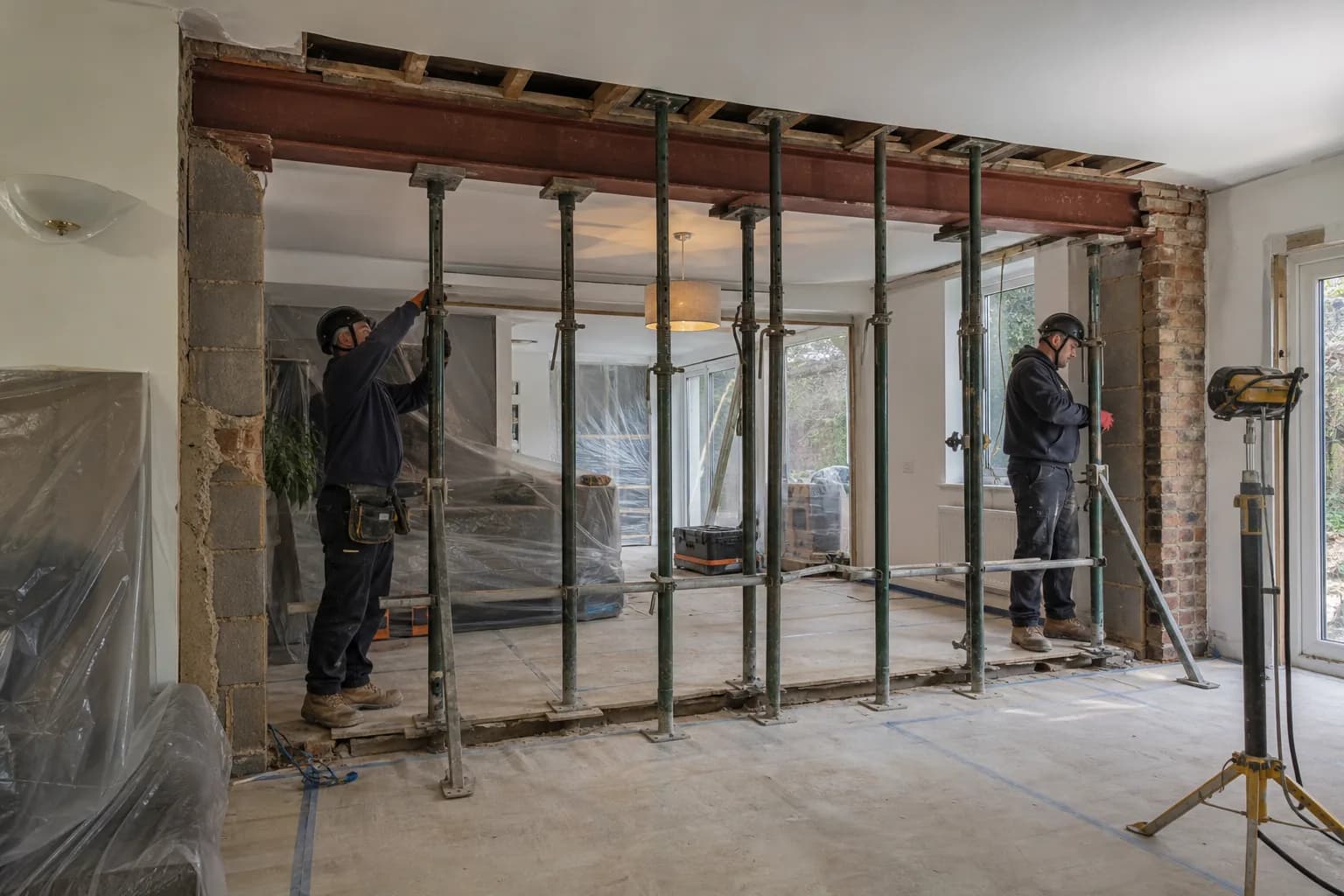 Temporary supports protecting a home while a structural opening is formed