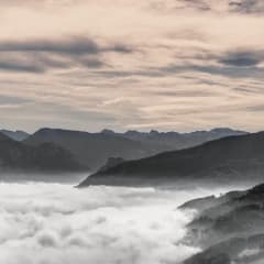 Mountain ridges rising above low clouds