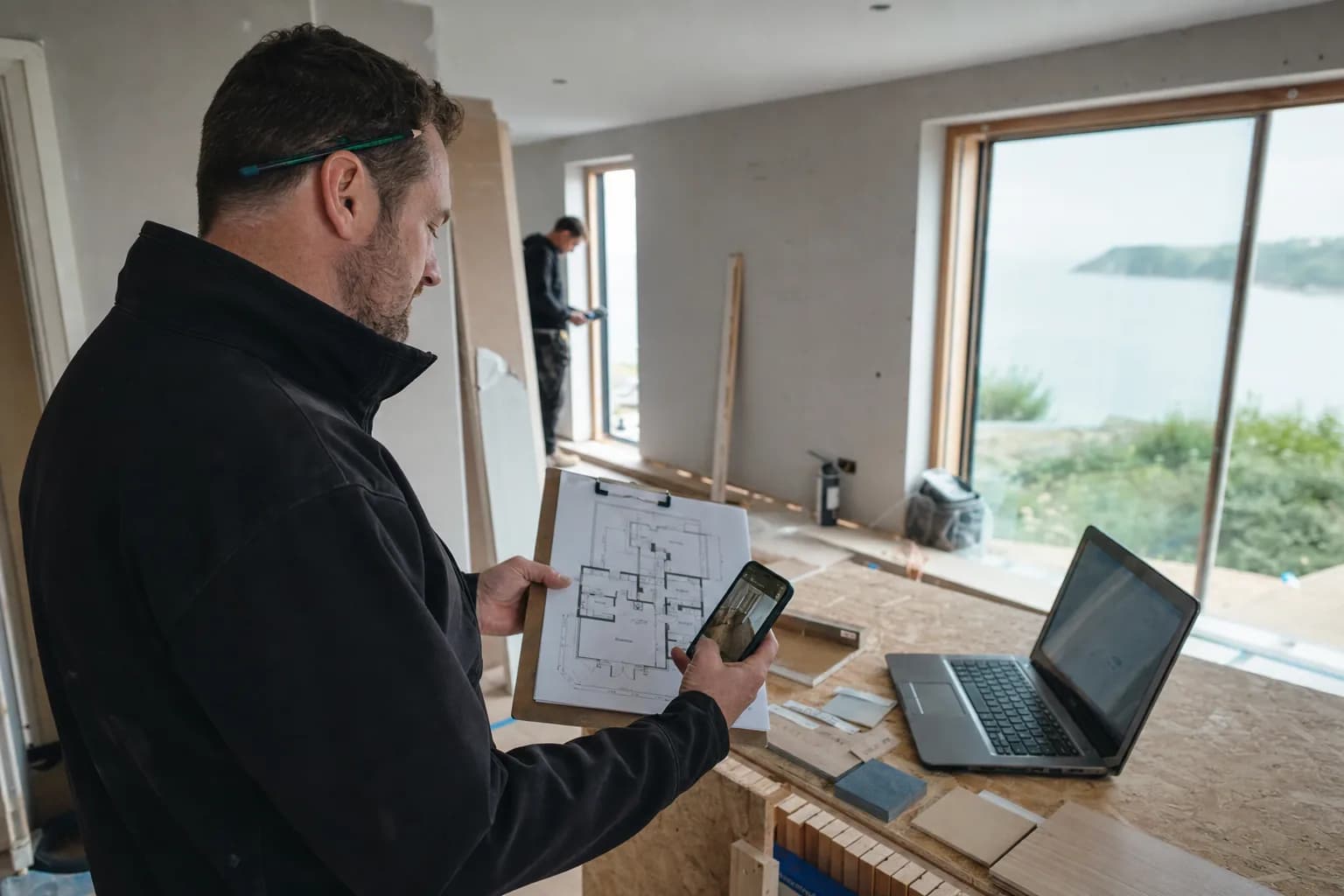Project manager documenting progress and reviewing drawings on a Dorset renovation Project manager documenting progress and reviewing drawings on a Dorset renovation
