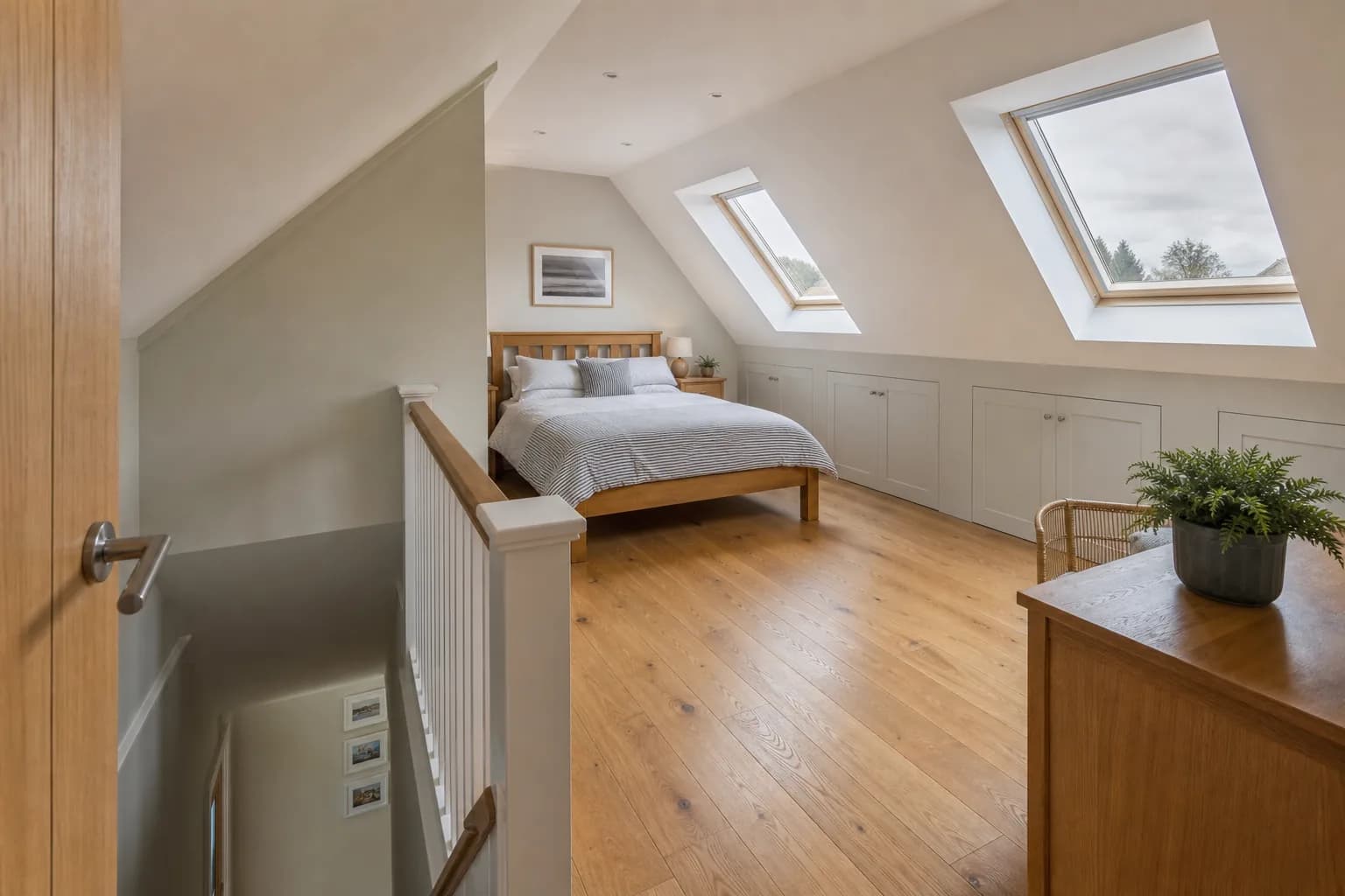 Completed Dorset loft bedroom with roof windows, eaves storage and a new stair Completed Dorset loft bedroom with roof windows, eaves storage and a new stair